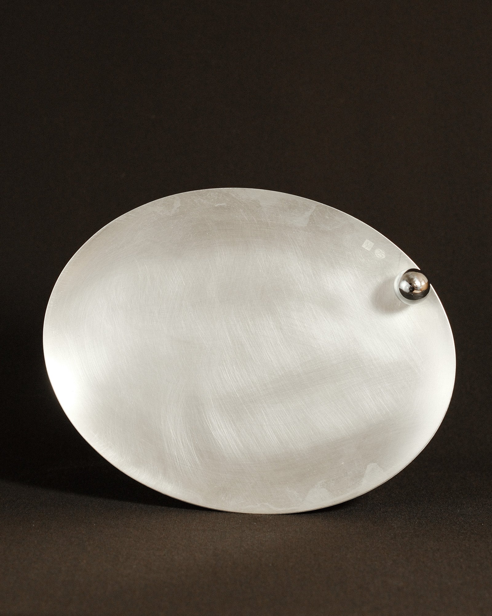Yeodong Yun Plate 4 silver-plated copper vessel with oval form and polished sphere anchoring one edge.