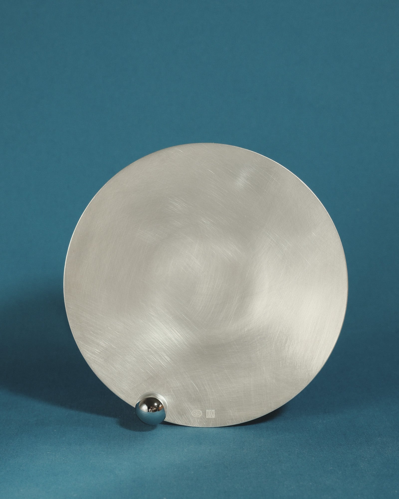 Yeodong Yun Plate 1 silver-plated copper vessel with near-flat surface interrupted by a single polished sphere.