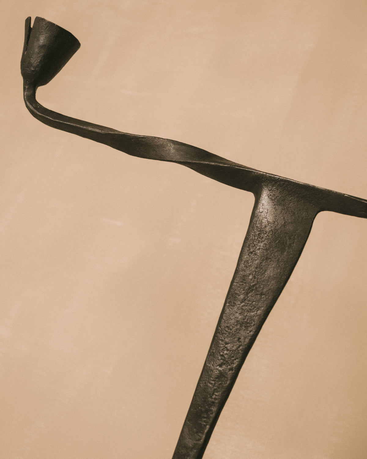 Forged iron Campanula Candle Holder by Agnieszka Owsiany, angled view showing tripod stem