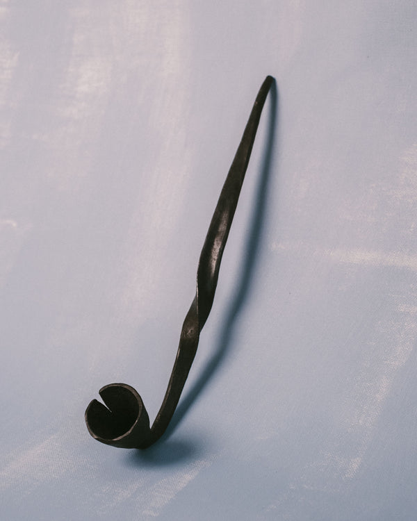 Bell detail of Campanula Snuffer by Agnieszka Owsiany, hand-forged with traces of the forging process