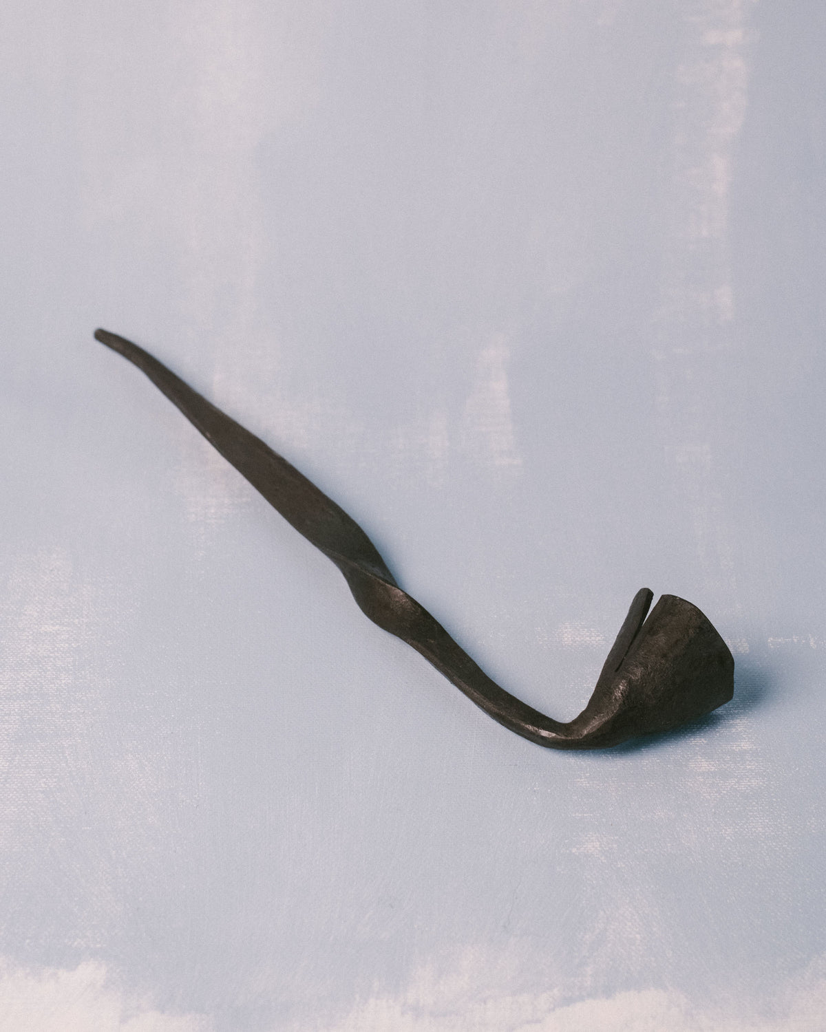 Handle end of Campanula Snuffer by Agnieszka Owsiany, hand-forged with subtle variations from the metalwork