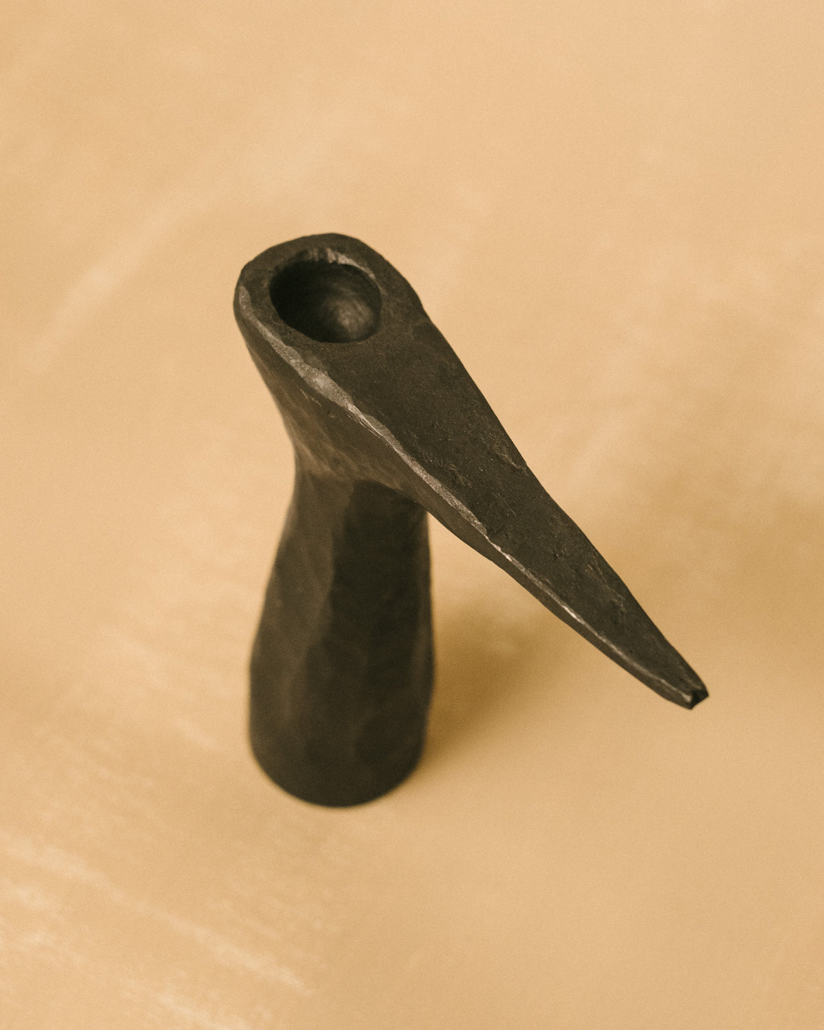 Forged steel candle holder by Agnieszka Owsiany, curved arm, angled view