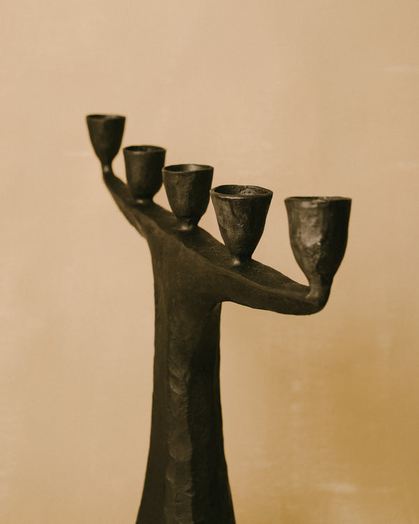 Forged steel candle holder by Agnieszka Owsiany, branching arm structure, angled view