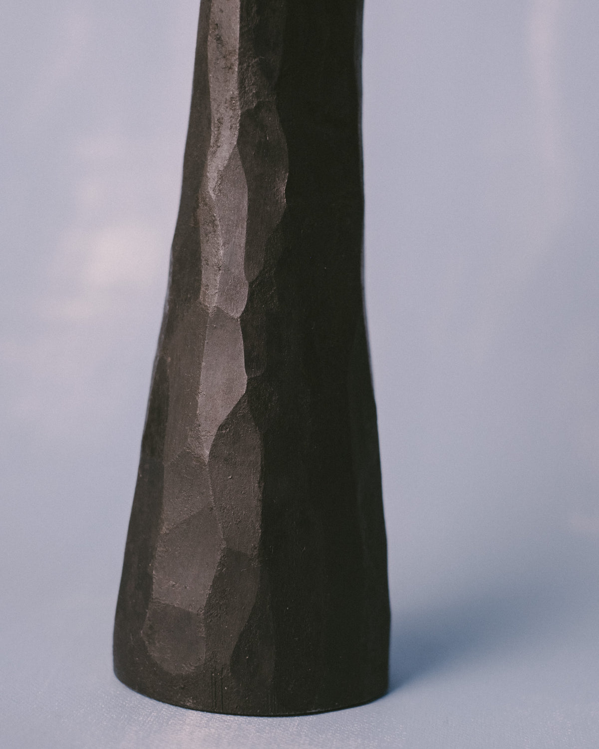 Forged stem of Agnieszka Owsiany's candle holder, textured steel surface, close-up