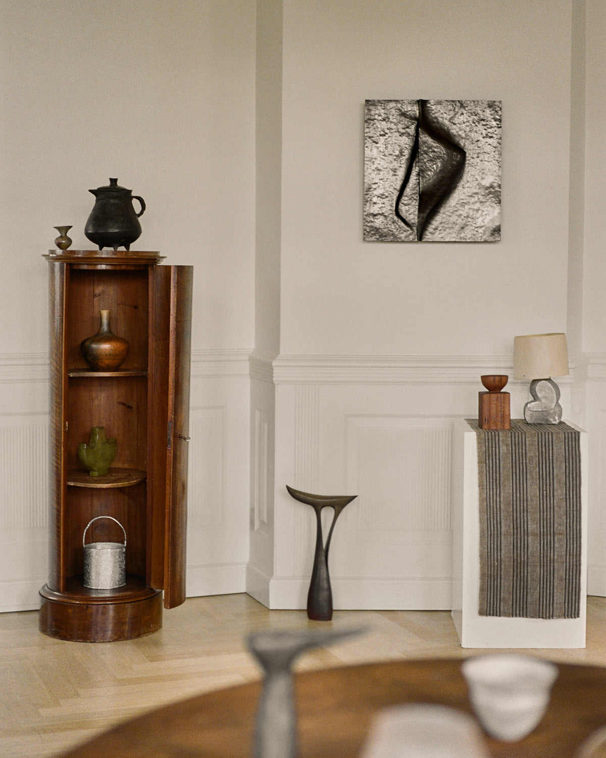 Sculptural Mirror Cabinet by Agnieszka Owsiany shown in styled interior, forged copper wall piece