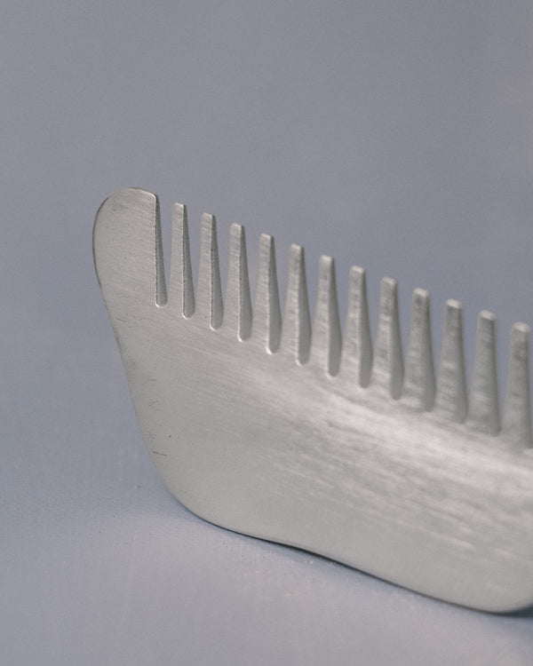 Alternate profile of Christian+Jade Comb in silver-plated metal, sculptural balance for the hand