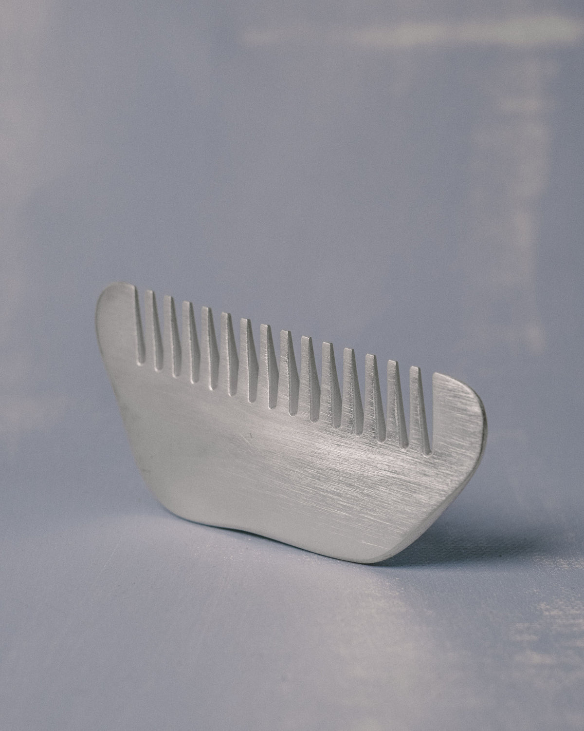Silver-plated Comb by Christian+Jade, upright view showing polished refinement and tactile weight