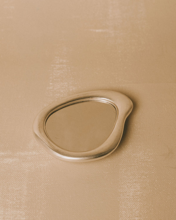 Silver-plated Mirror by Christian+Jade, top-down view showing sculptural pebble form