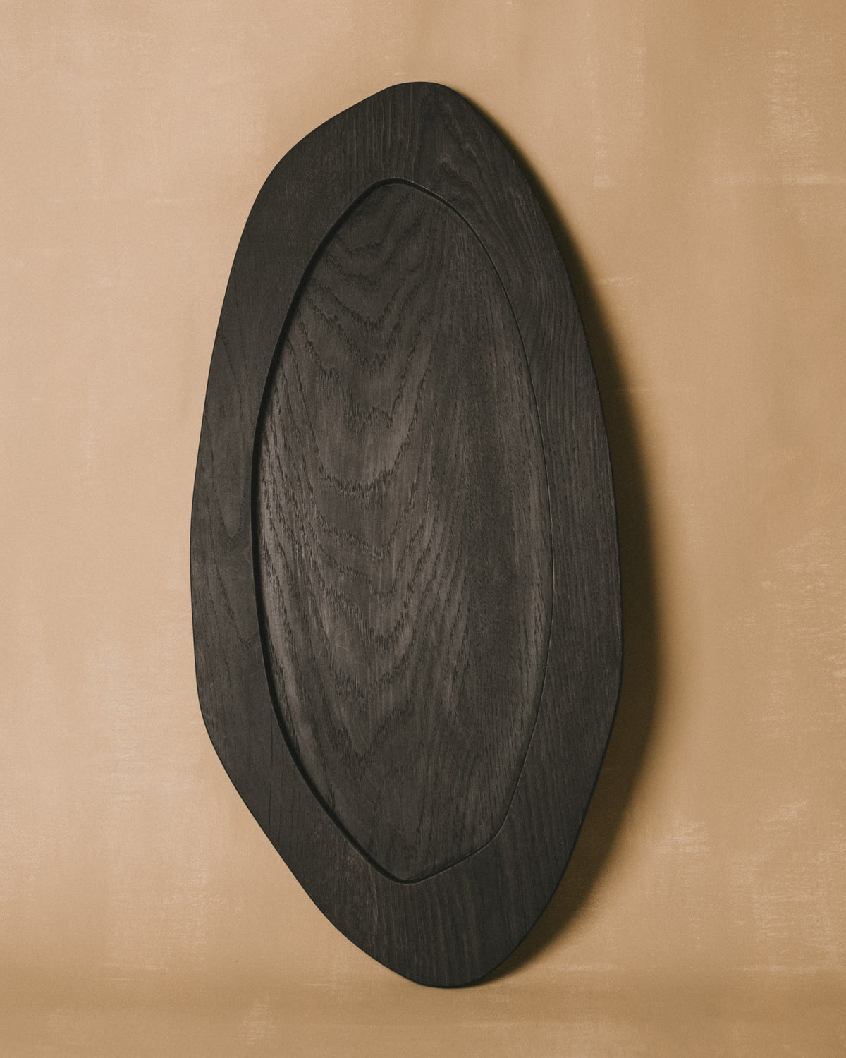 Christian+Jade Tray, carved oxidised oak from the Woodenware series, top-down view showing sculptural oval form