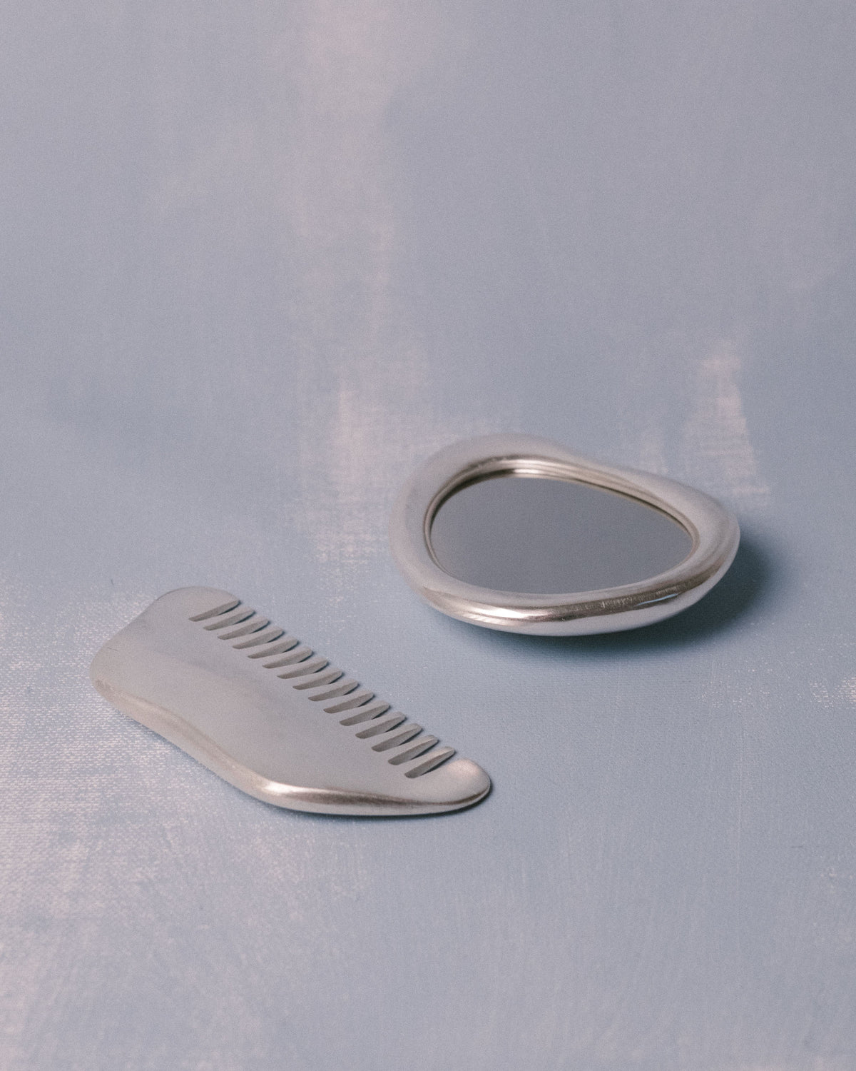 Close-up of silver-plated comb, Christian+Jade Vanity Set, polished stainless steel finish
