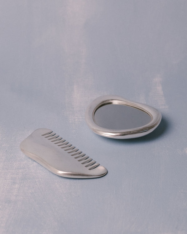 Close-up of silver-plated comb, Christian+Jade Vanity Set, polished stainless steel finish