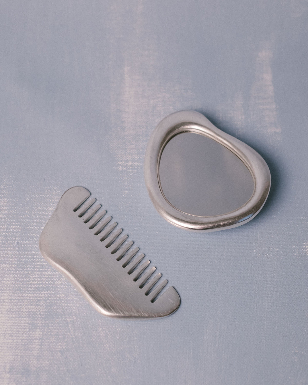 Christian+Jade Vanity Set, silver-plated mirror and comb in polished stainless steel, full view of both companion pieces