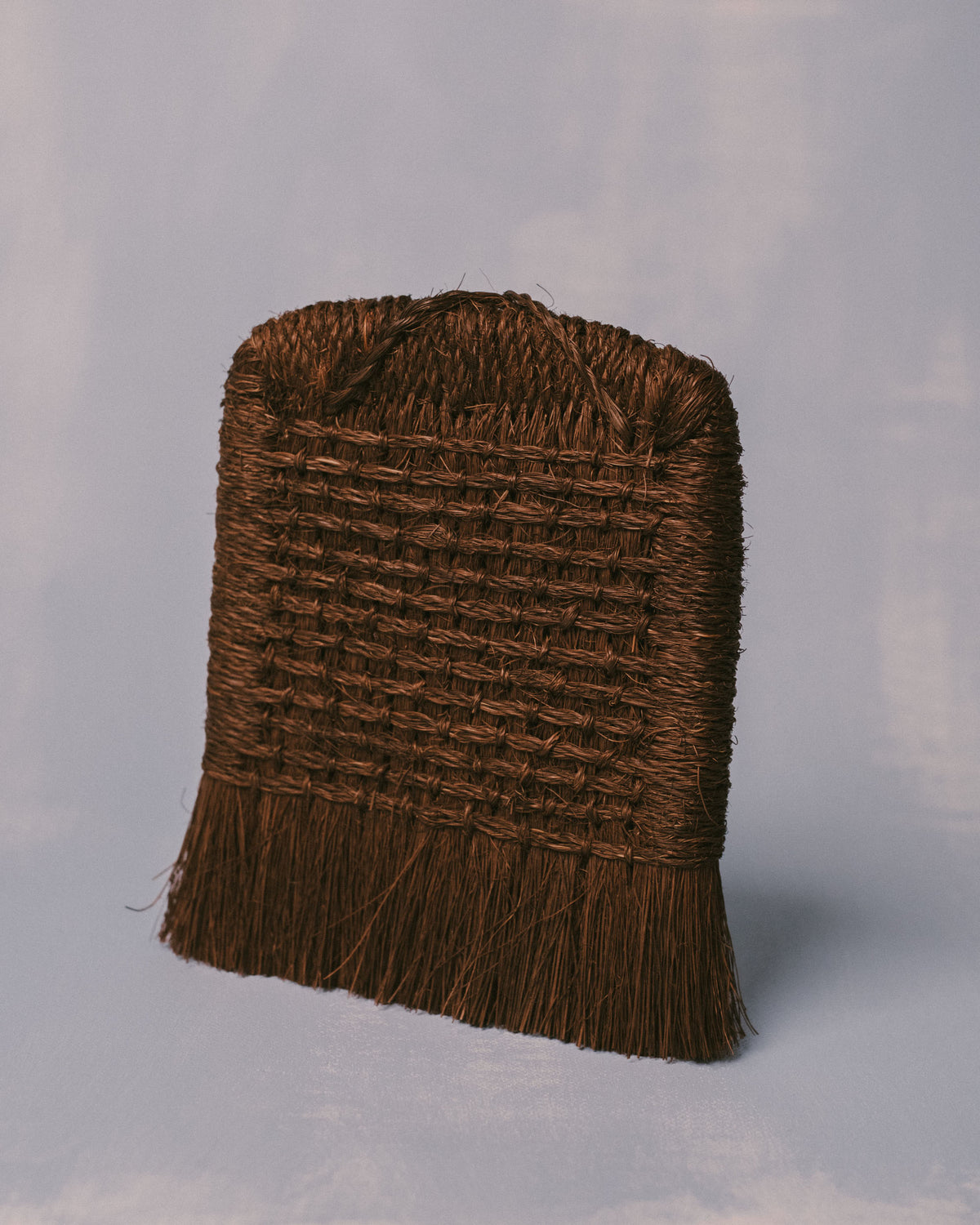 Palm fiber brush handwoven in Taiwan, angled front showing bound horizontal layers
