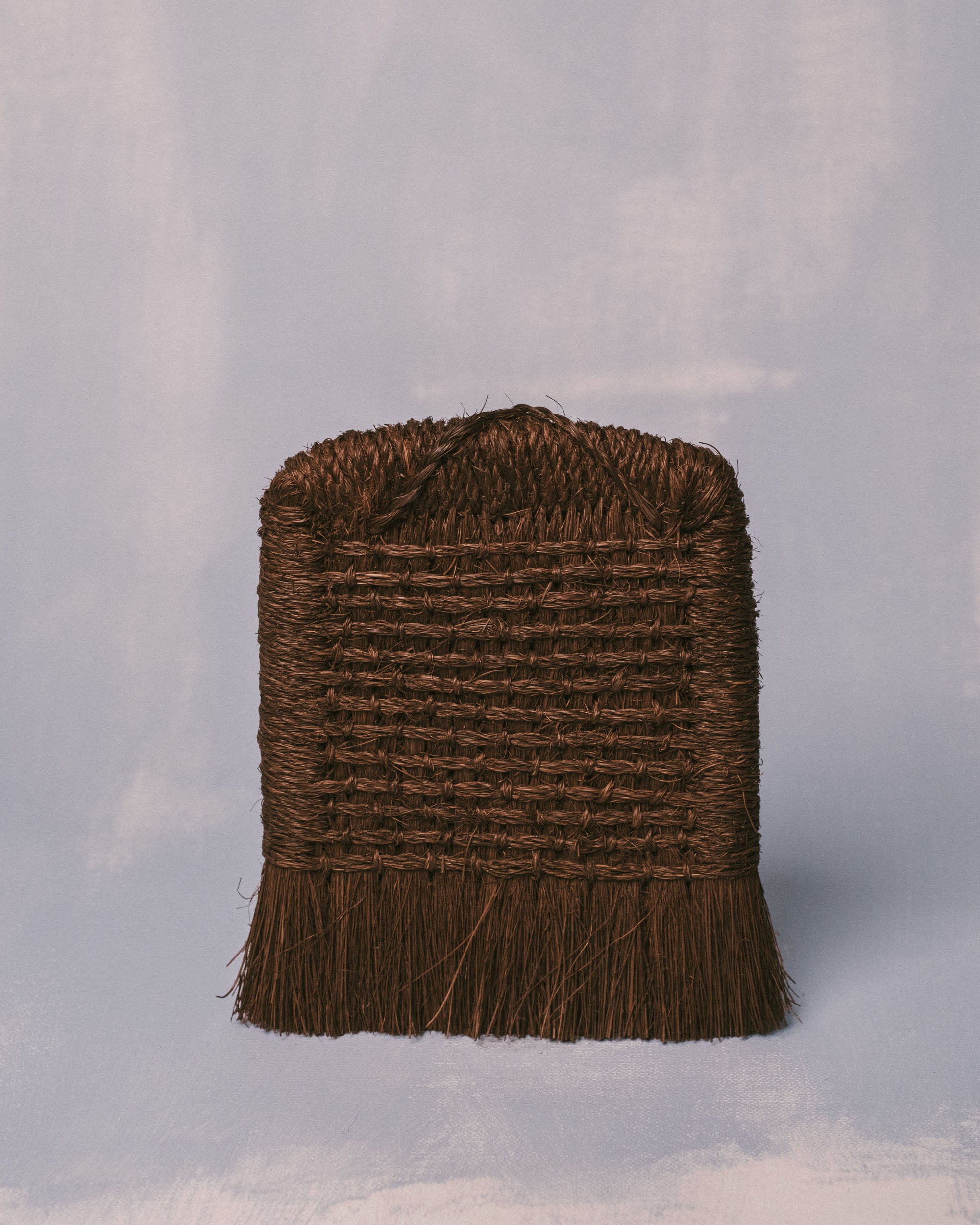 Handwoven palm fiber brush from Taiwan with tightly bound horizontal layers and cut fringe