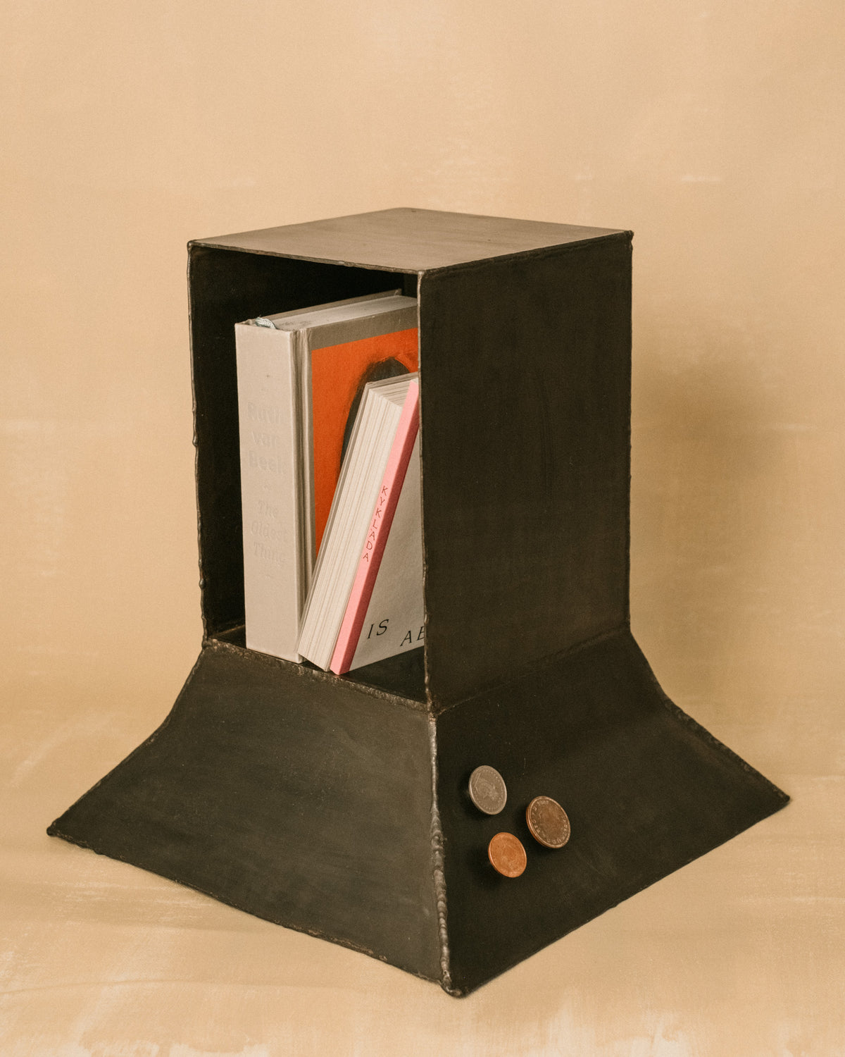 Eternal Elder Vitrine by Hannah Kuhlmann showing three magnetic Lucky Pennies inside the patinated steel frame
