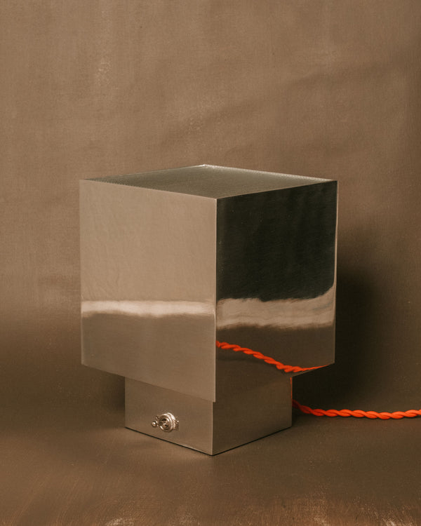 J. Hannah Table Lamp 01, cast polished aluminium base topped with ribbed glass shade, front view showing architectural form