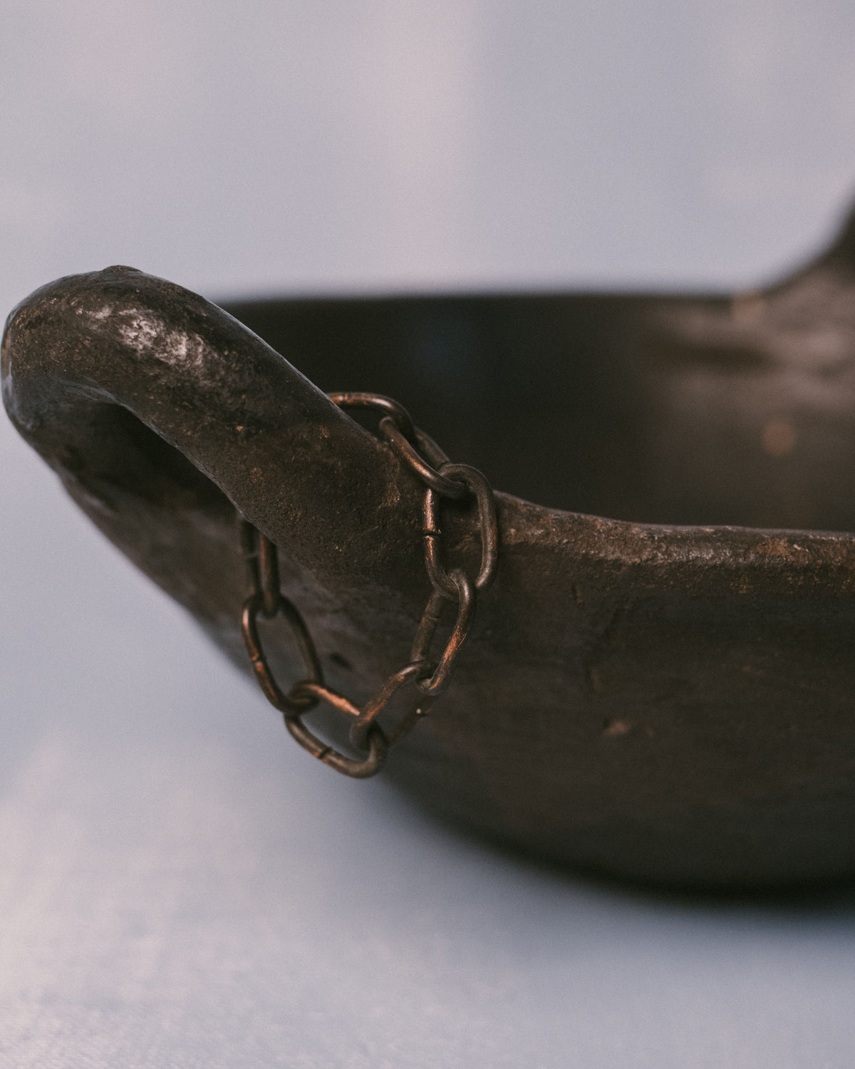 Rounded lip of Jydepotter colander, Danish blackware, opposite side view