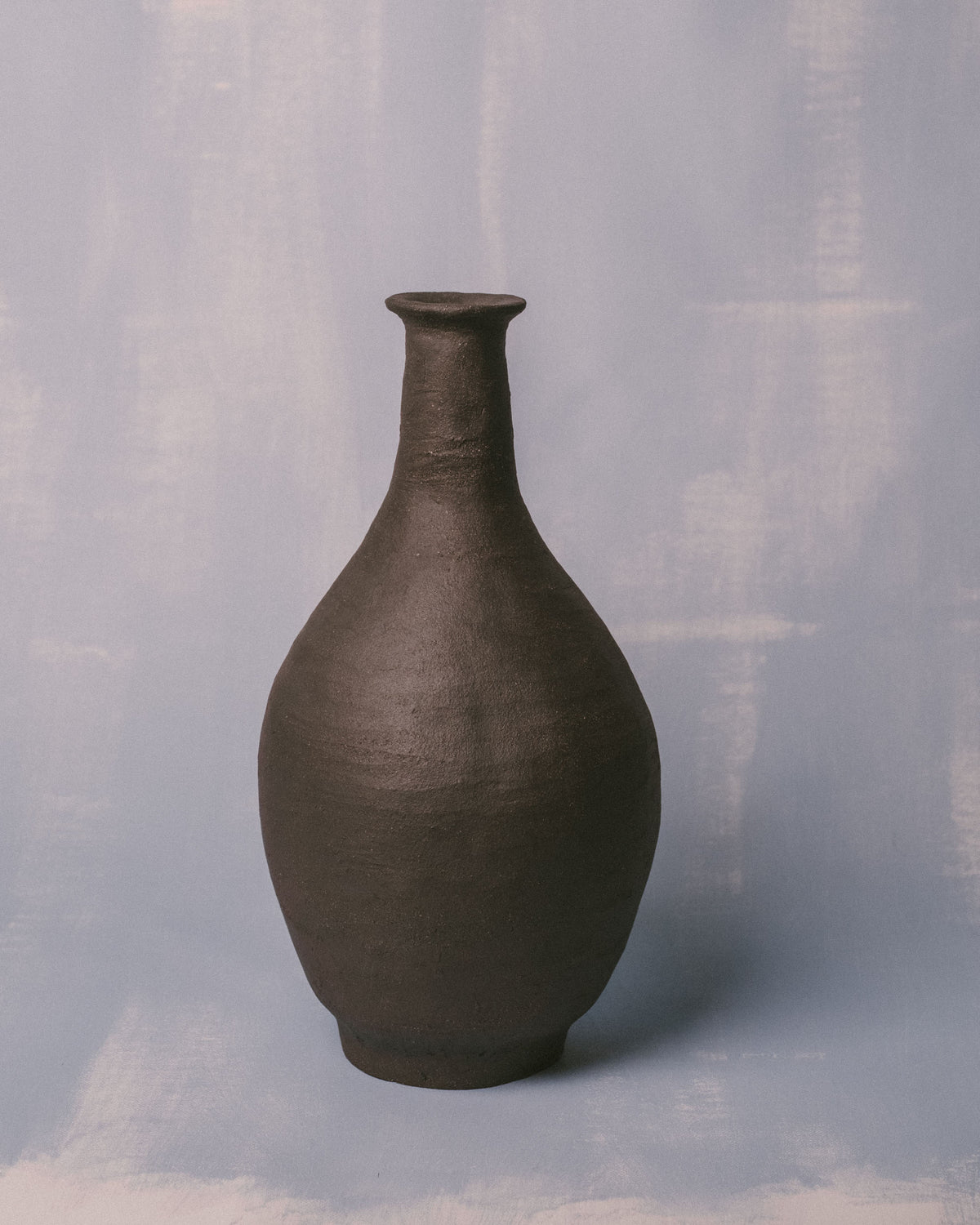 Back view of Necked Vessel I, natural clay tone and texture