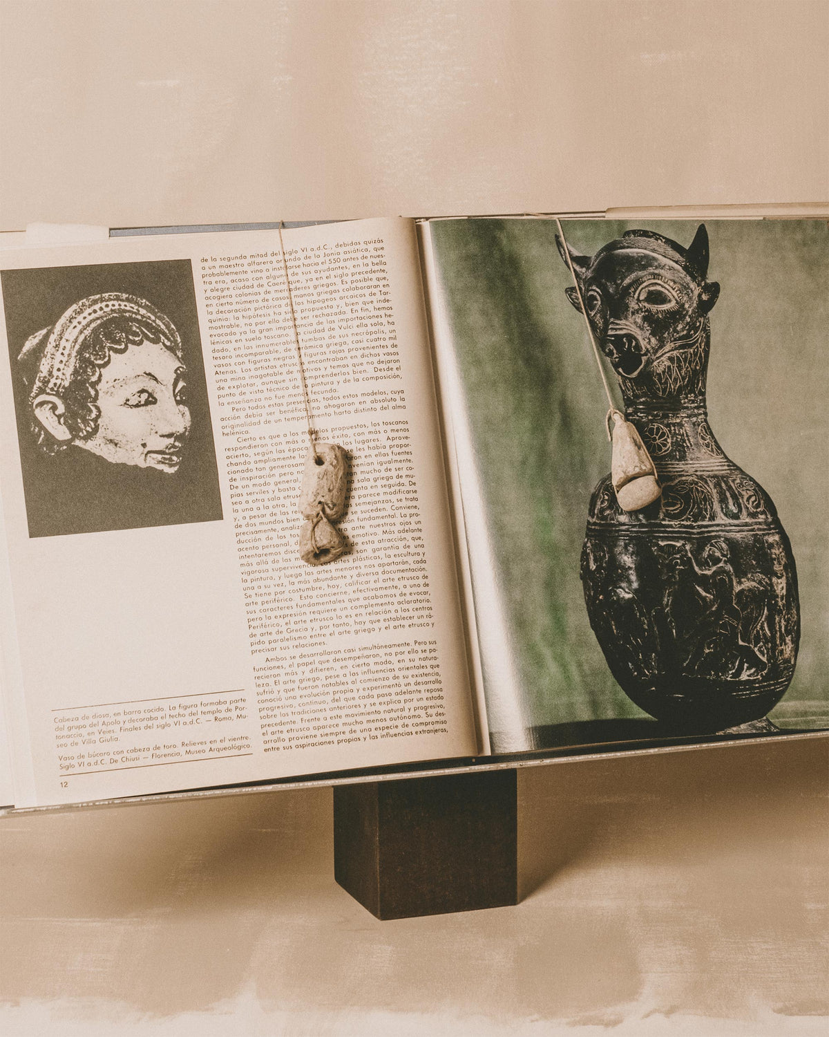Book Stand by Louie Isaaman-Jones in use, holding an open book with lead loom weights