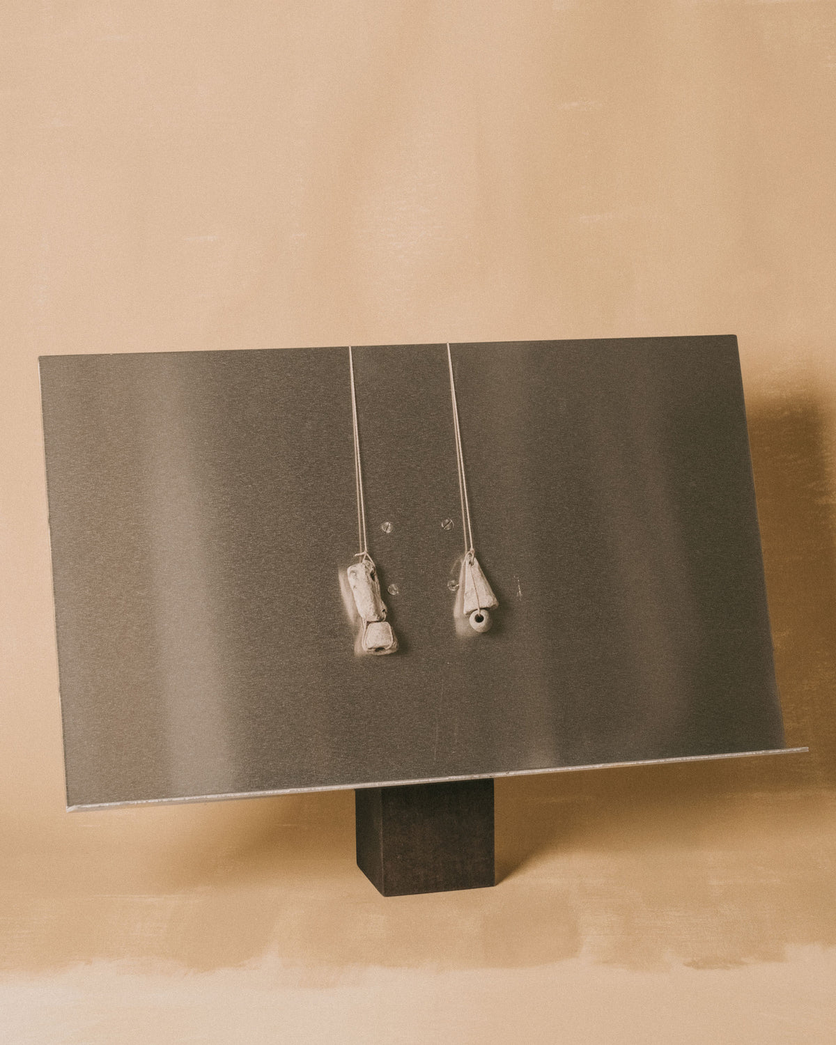 Louie Isaaman-Jones Book Stand with two vintage lead loom weights, front view showing display panel and base
