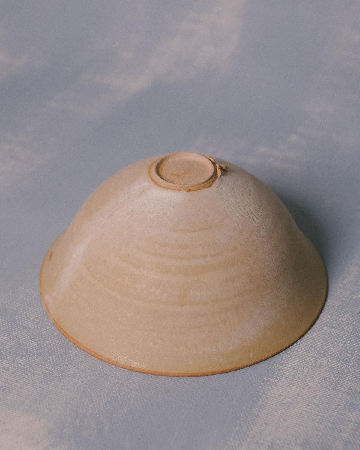 Miso Bowl by Sharlen Nozawa shown inverted, revealing base of hand-shaped white stoneware