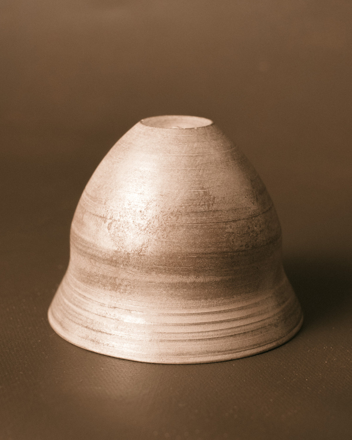 Sharlen Nozawa Silver Lustre Cup shown inverted, revealing base of hand-thrown ceramic