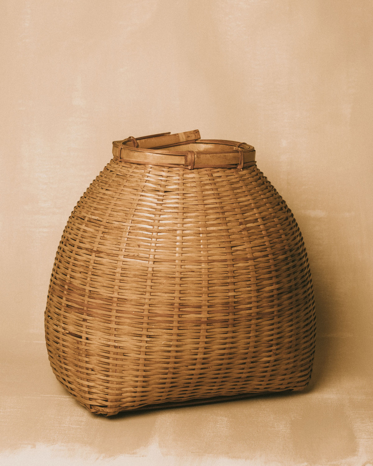 Rounded base of woven bamboo basket, side profile