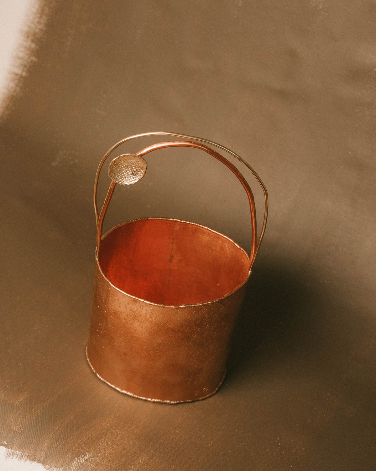 Top-down view of Basket 3 opening, hand-worked copper rim