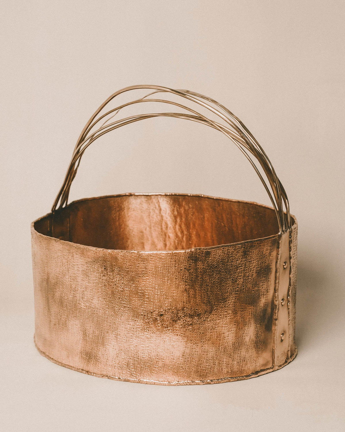 Curved brass handle of Yeodong Yun's Basket 4, angled view