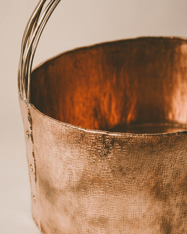 Angled view into Basket 4, hand-worked copper interior