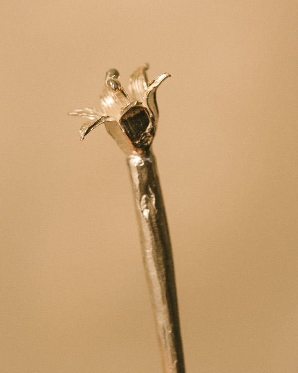 Single Dessert Pick by Yeodong Yun, sculptural silver with flower captured in early bud stage