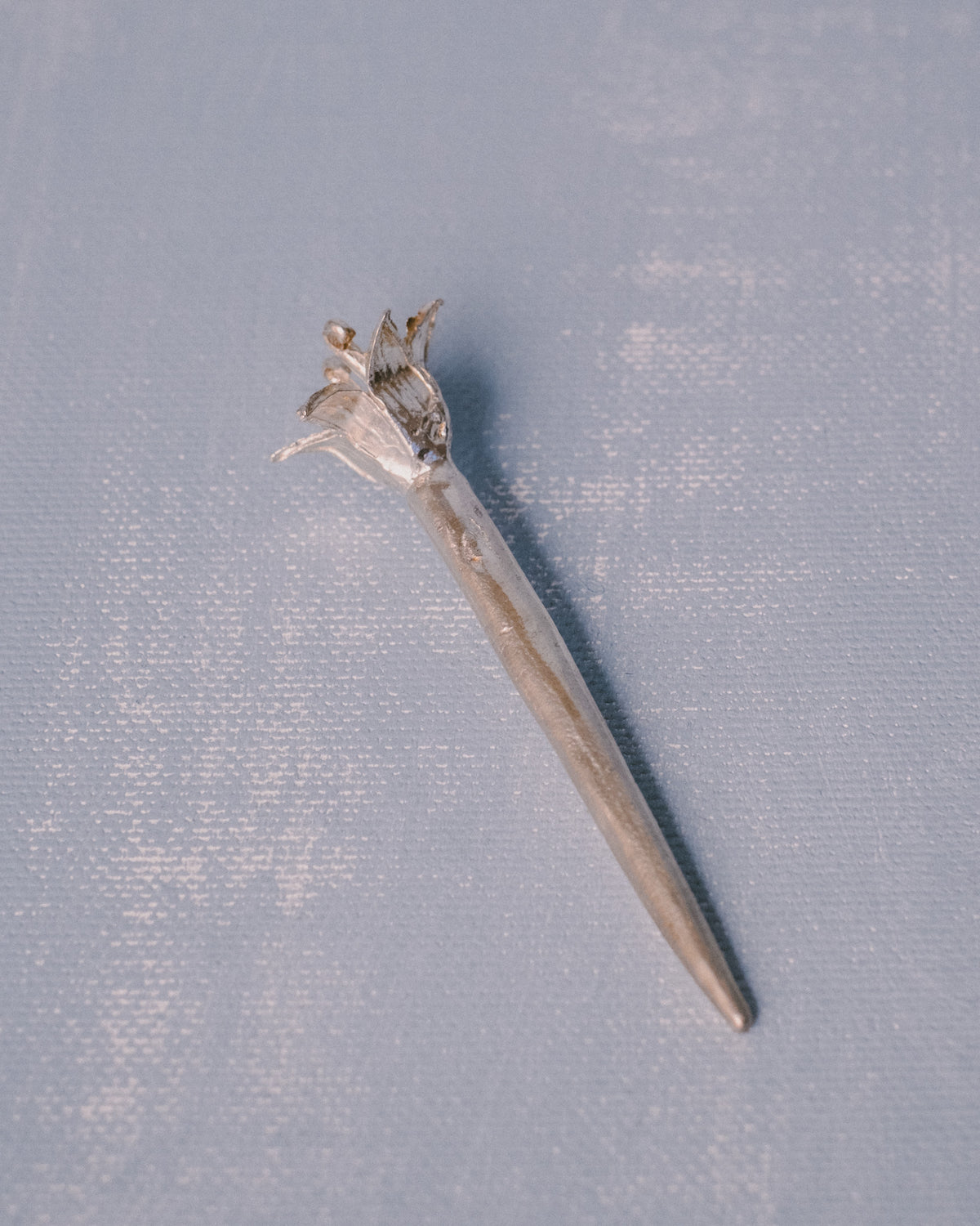 Sculptural silver Dessert Pick by Yeodong Yun, flower captured mid-bloom