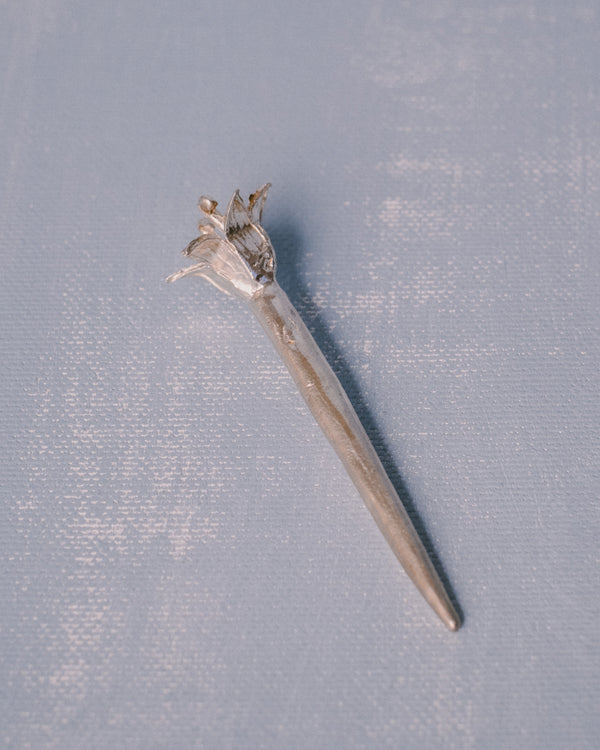 Sculptural silver Dessert Pick by Yeodong Yun, flower captured mid-bloom