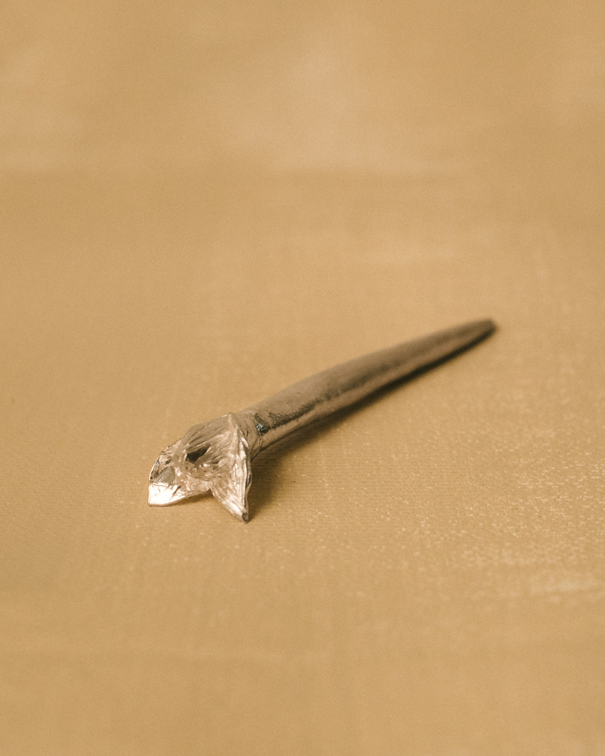 Yeodong Yun Dessert Picks laid at angle, handmade silver picks with sculptural flower tops