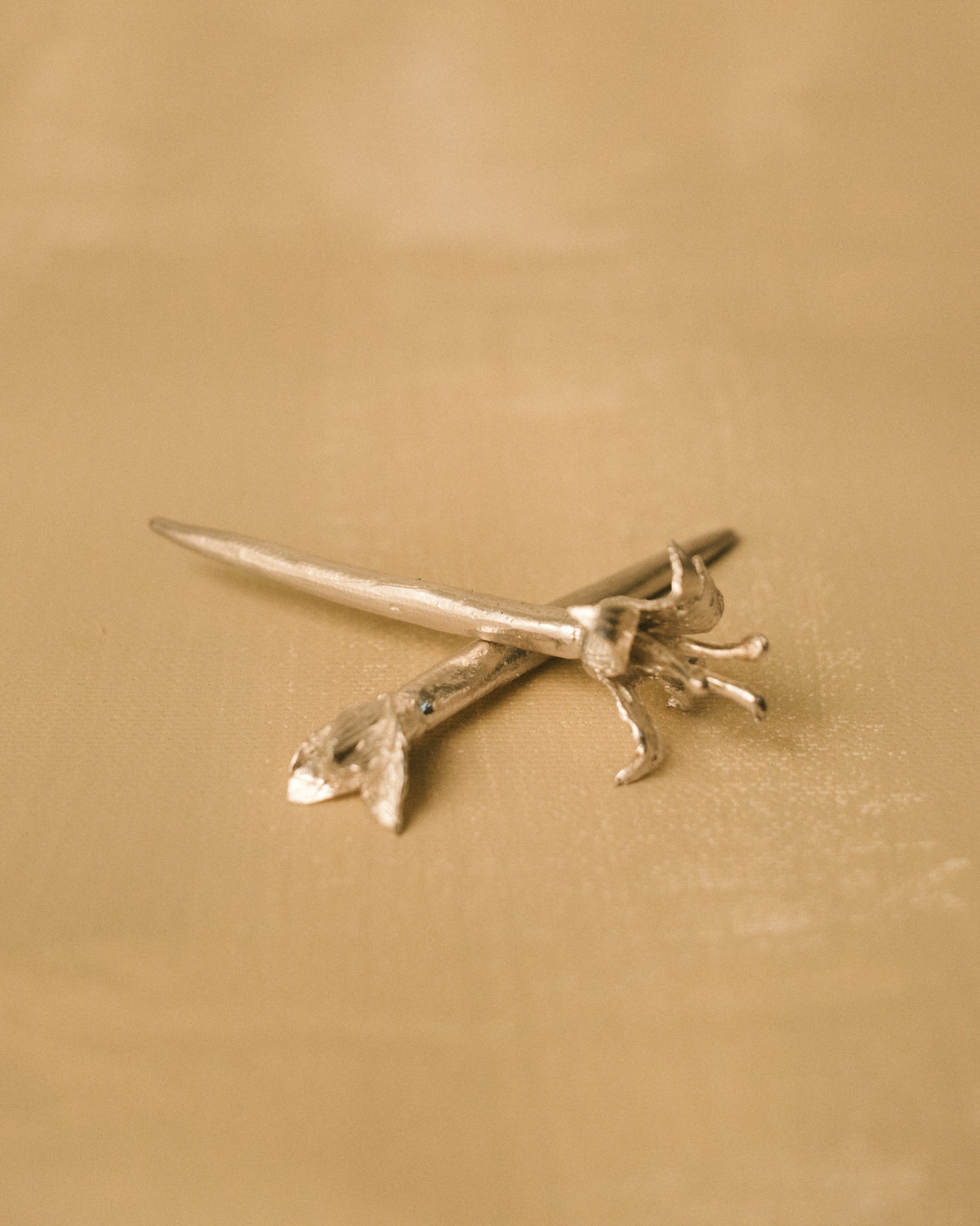 Pair of Yeodong Yun Dessert Picks crossed, sculptural silver with flower details at different bloom stages