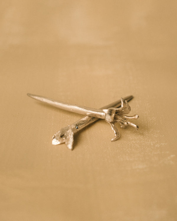 Pair of Yeodong Yun Dessert Picks crossed, sculptural silver with flower details at different bloom stages