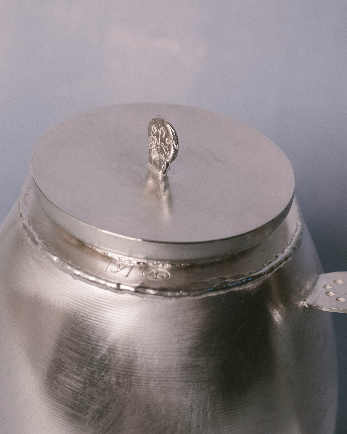 Close-up of Kettle lid and handle, silver-plated copper texture