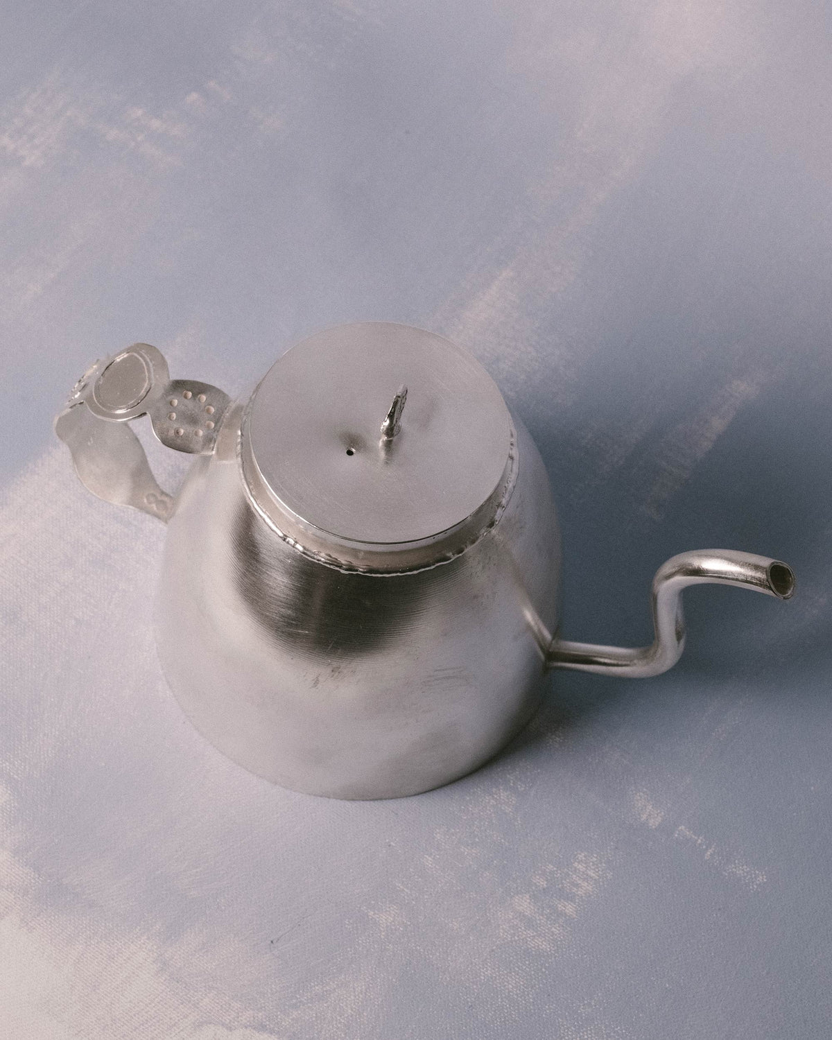 Top-down view of Yeodong Yun's Kettle, hand-worked lid detail