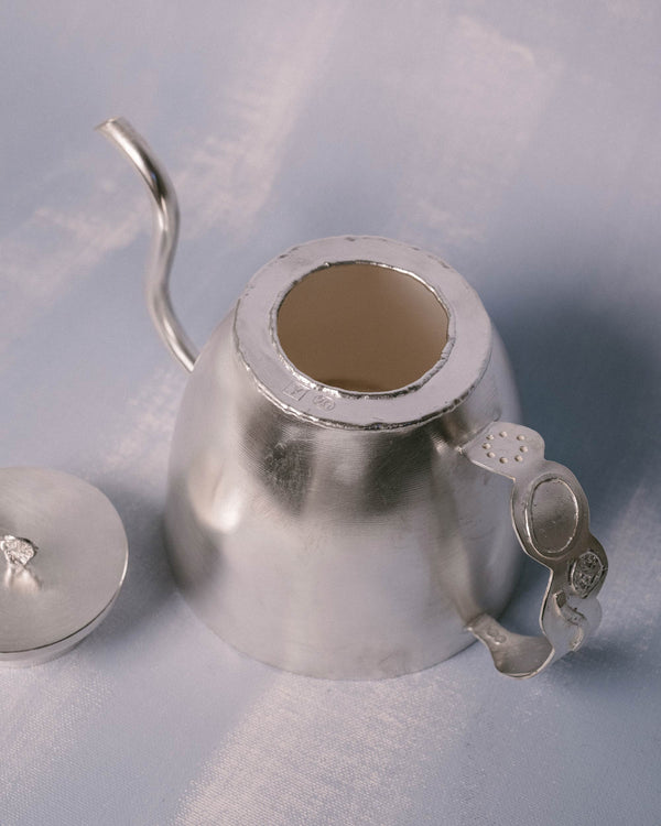 Angled view into Kettle opening, tactile silver-plated surface