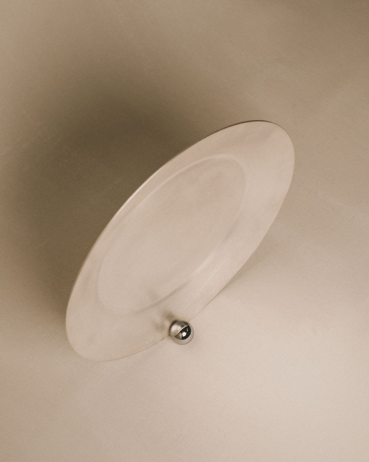Side profile of Yeodong Yun Plate 2, showing polished sphere anchoring the silver-plated copper form